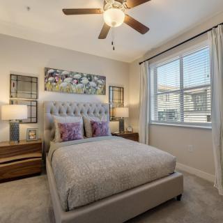 A modern bedroom with elegant decor and a large window for natural light.