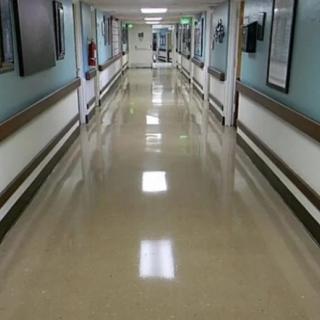 A clean, empty hospital corridor with bright lighting.