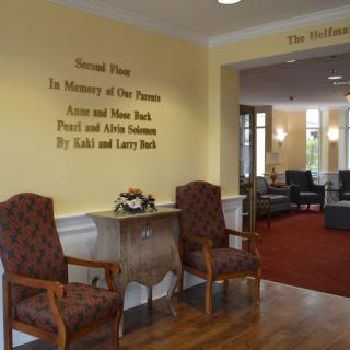 A cozy lobby area with dedicated plaques and chairs.