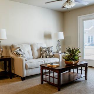 A cozy and inviting living room featuring a comfortable sofa, stylish coffee table, and soft lighting.
