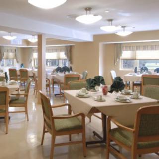 A spacious and elegantly decorated dining room with tables set for a meal.