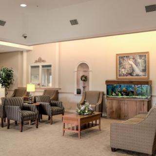 A cozy lobby with comfortable seating and an aquarium centerpiece.