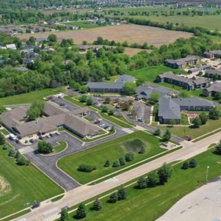 Aerial view of a suburban area with buildings and surrounding greenery.