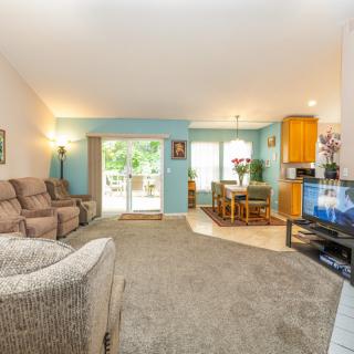 Cozy open floor plan living room with a connected kitchen and dining area.