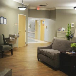 A cozy waiting room with comfortable seating and warm lighting.