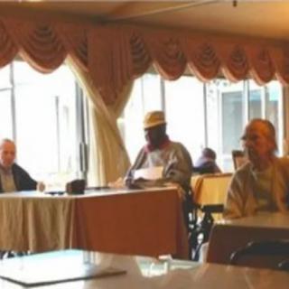 A group of people engaged in a meeting inside a conference room.