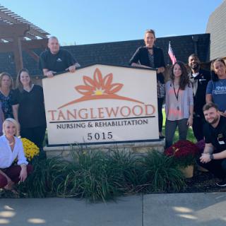 Team members gathered in front of Tanglewood Rehabilitation Center, showcasing their commitment to care and community.