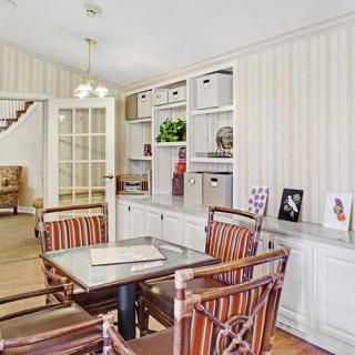 A well-organized office space with shelves and stylish furniture.