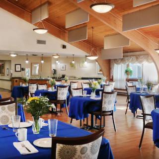 An elegant indoor dining area with blue tablecloths and sophisticated decor.