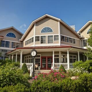 A beautiful residential building featuring elegant architecture and lush gardens.