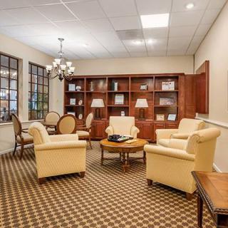 A cozy office lounge area with comfortable seating and bookshelves.