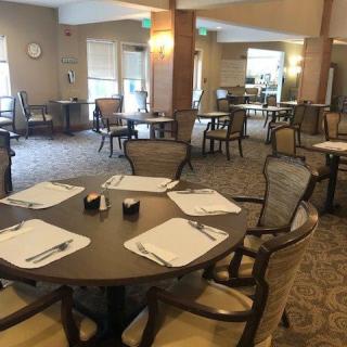 An empty dining area with neatly set tables and chairs.