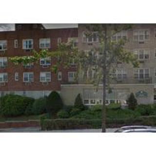 A residential apartment building with landscaping in front.