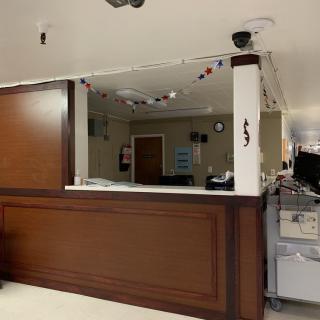 An empty hospital reception desk with festive decorations.