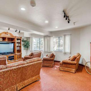 Cozy living room with comfortable sofas and a large television.