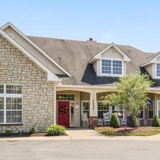 A spacious residential house with a brick exterior and well-maintained landscaping.