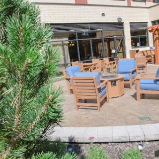 A cozy outdoor seating area surrounded by greenery, perfect for relaxation.