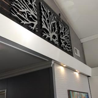 Stylish wall decor featuring abstract coral designs, complemented by ambient lighting.