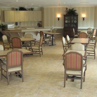 A spacious dining area with several tables and chairs arranged neatly.