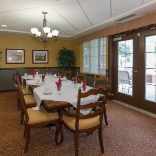 A well-appointed dining room with a neatly set table and elegant furniture.