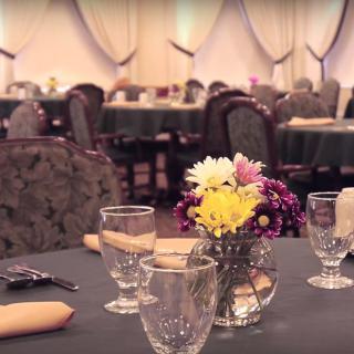 A formal dining setup with floral centerpiece and neatly arranged tableware.