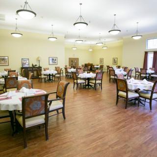 A well-decorated dining area with neatly arranged tables and chairs.