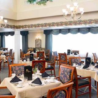 An elegantly decorated dining room with tables set for guests.
