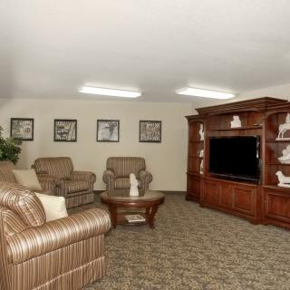 A cozy living room with comfortable seating and a large entertainment center.