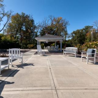A tranquil park setting with a gazebo and benches on a sunny day.