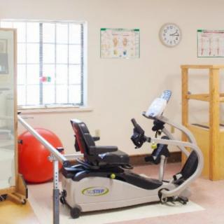 A fitness room with exercise equipment including a recumbent bike.