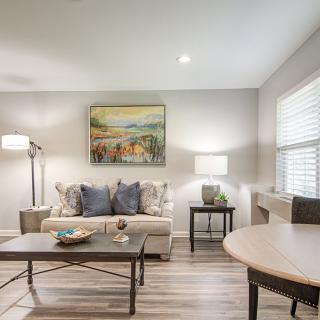 A modern living room with a comfortable sofa, stylish coffee table, and elegant lighting.