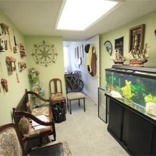 A cozy room with nautical-themed decor, featuring a large aquarium and vintage furniture.