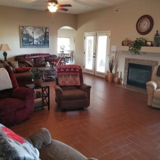 A cozy living room with comfortable seating, a fireplace, and tasteful decor.