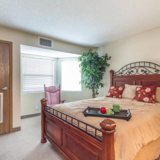 Cozy bedroom with a wooden bed and decorative elements.