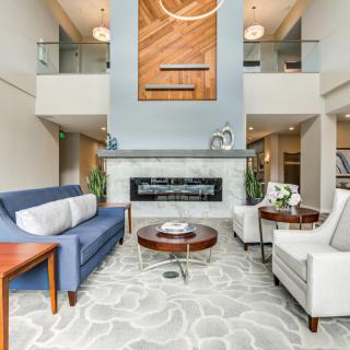 A modern living room with a stylish fireplace, comfortable seating, and elegant decor.