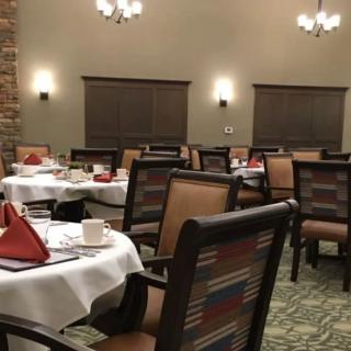A cozy restaurant dining room with neatly arranged tables and chairs.