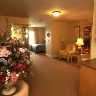 A cozy living room with floral decorations and soft lighting.