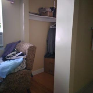 A glimpse of a cozy living area featuring a closet and comfortable seating.