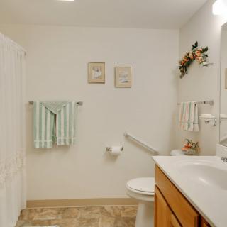 A neatly organized bathroom with towels, a toilet, and a sink.