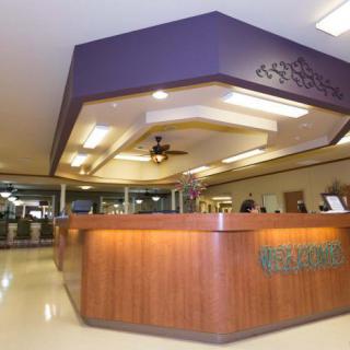 A hotel reception desk in a well-lit lobby.