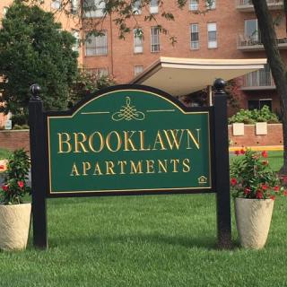 Sign for Brooklawn Apartments in front of a building.