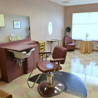 A salon interior with styling chairs and hairdressing equipment.
