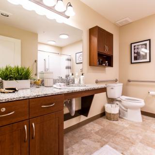 A modern bathroom with sleek cabinetry and warm lighting.