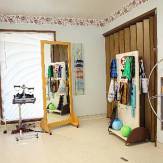 A rehabilitation room equipped with therapy tools and exercise equipment.
