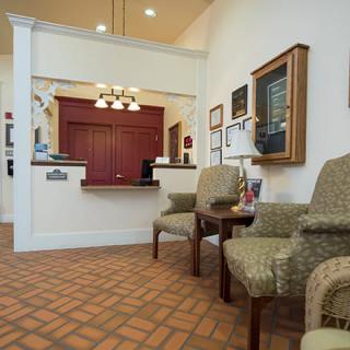 A cozy reception area with comfortable seating and warm lighting.