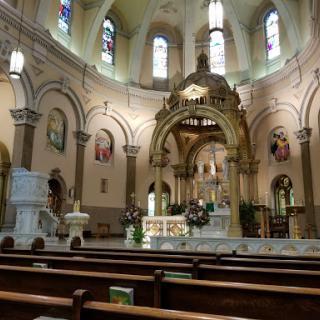 A serene view of a beautifully designed church interior, featuring ornate architecture and colorful stained glass windows.
