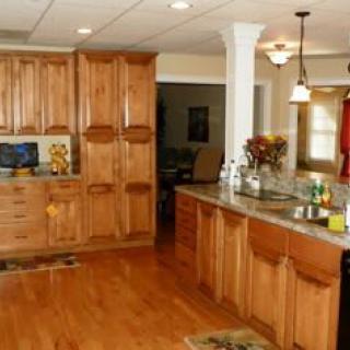 A cozy kitchen with wooden cabinets and a hardwood floor.