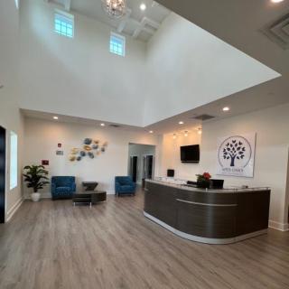 A modern office reception area with a sleek desk, comfortable seating, and stylish decor.