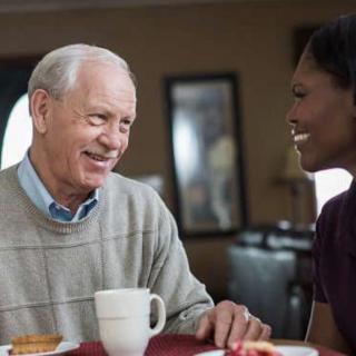 Two people enjoying a friendly conversation over coffee.