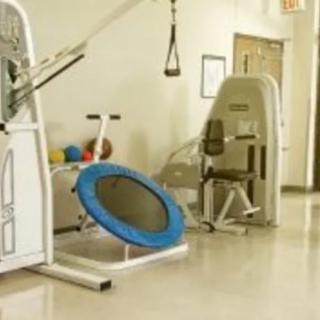 A gym area with various exercise machines and a small trampoline.